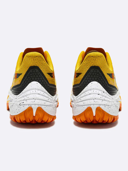 Yellow and black athletic running trail shoes with orange soles on a white background
