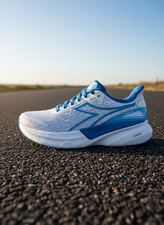 White and blue Diadora running shoe on tar road