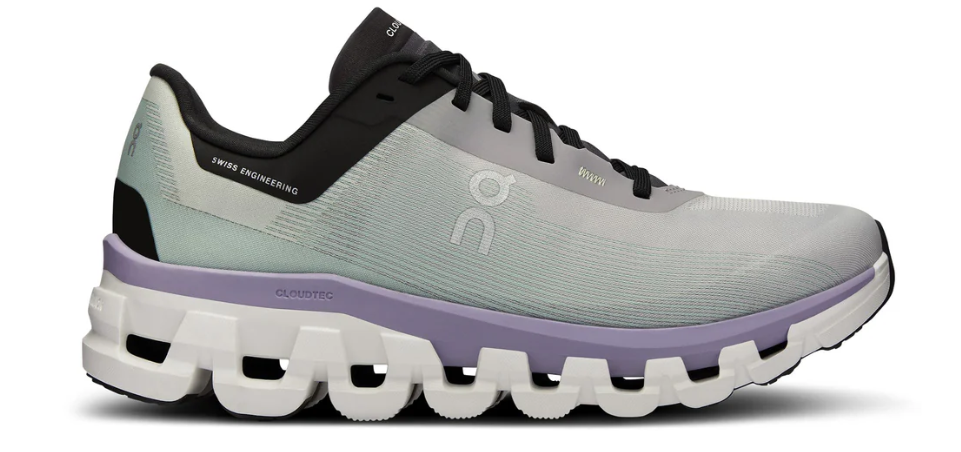 Gray and black running shoe with a white sole on a white background