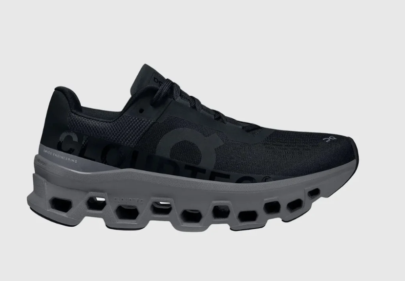 Black running shoe with unique sole design on a gray background