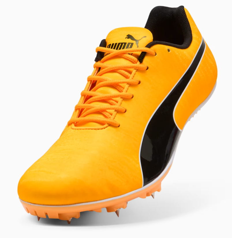 Yellow and black sports shoe with cleats on a white background