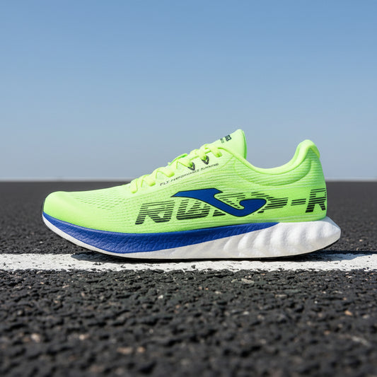 Bright green running shoe with blue sole on a white background