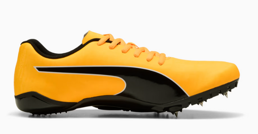 Yellow and black running shoe with cleats on a white background